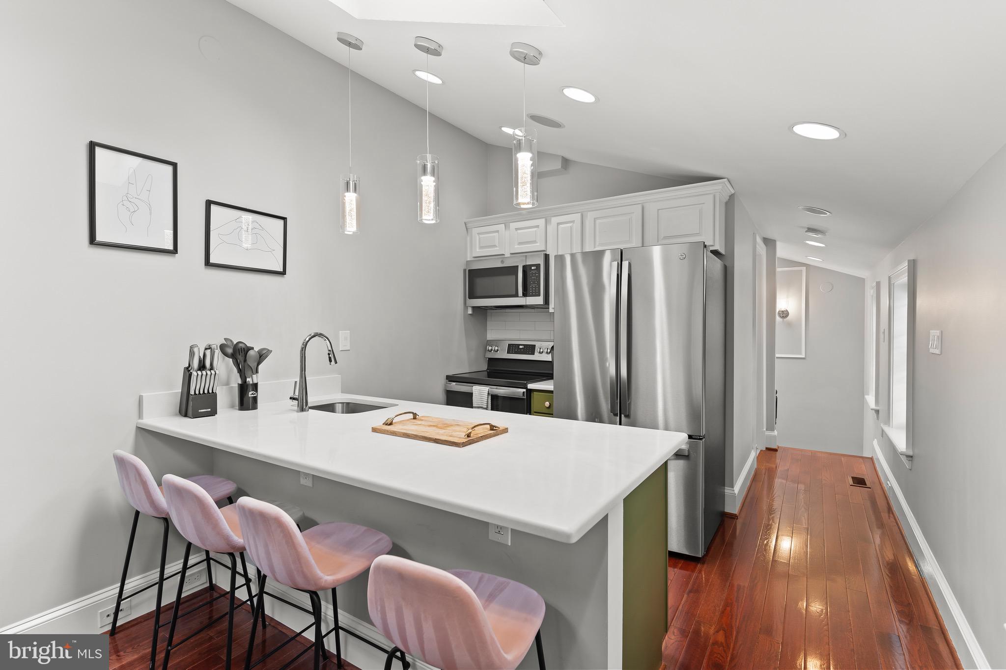 123 South Fayette Street Alexandria, VA 22314 - Photo 27 of 41 a kitchen with a table chairs refrigerator and cabinets