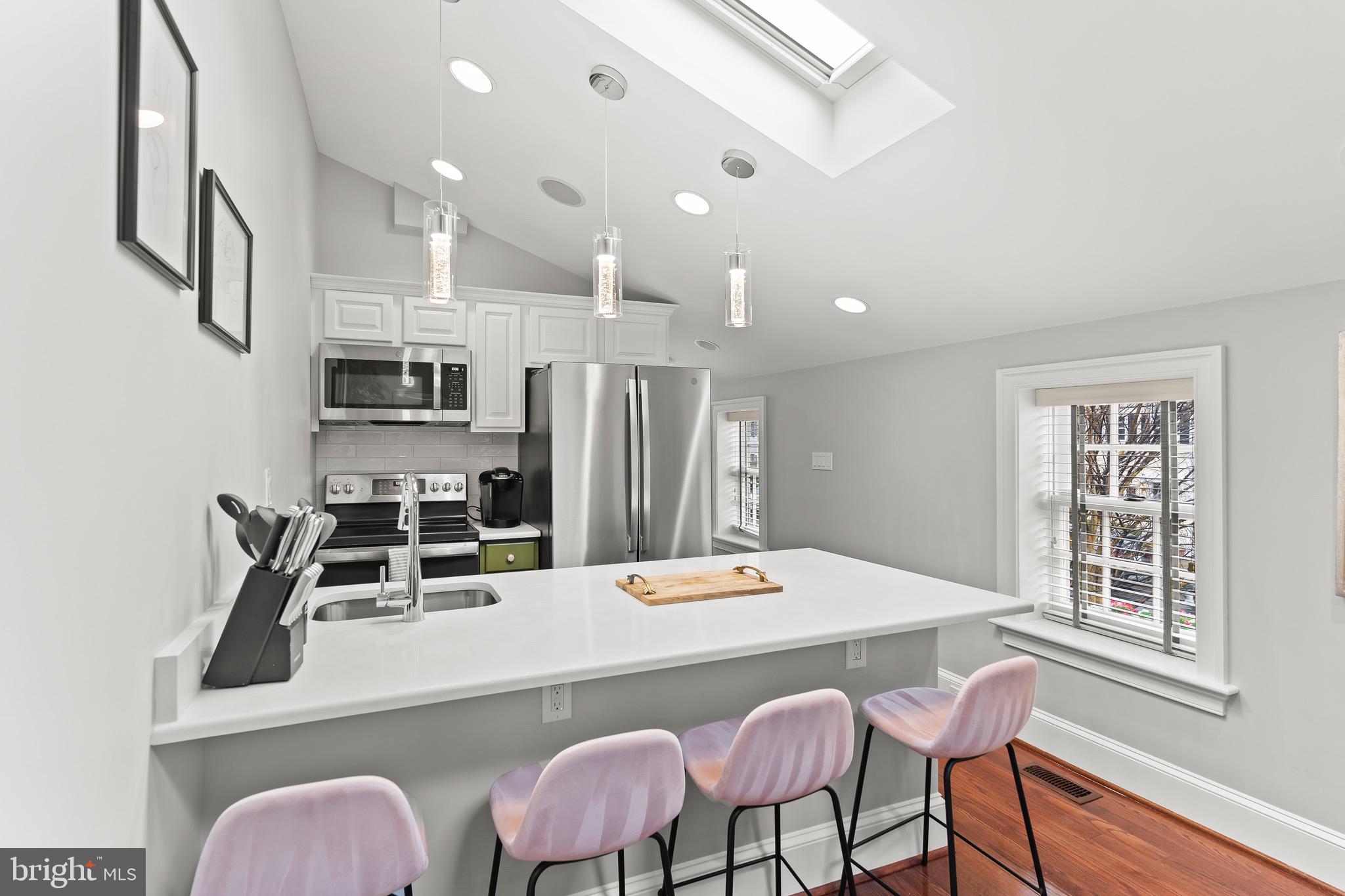 123 South Fayette Street Alexandria, VA 22314 - Photo 28 of 41 a kitchen with stainless steel appliances kitchen island granite countertop a kitchen island hardwood floor and a sink