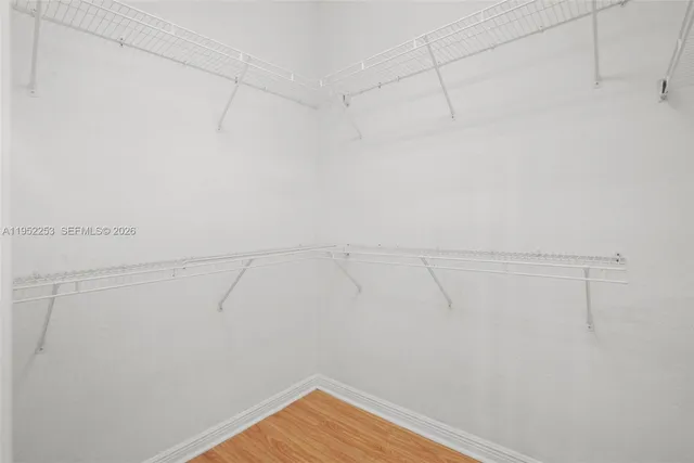 a view of an empty room and wooden floor