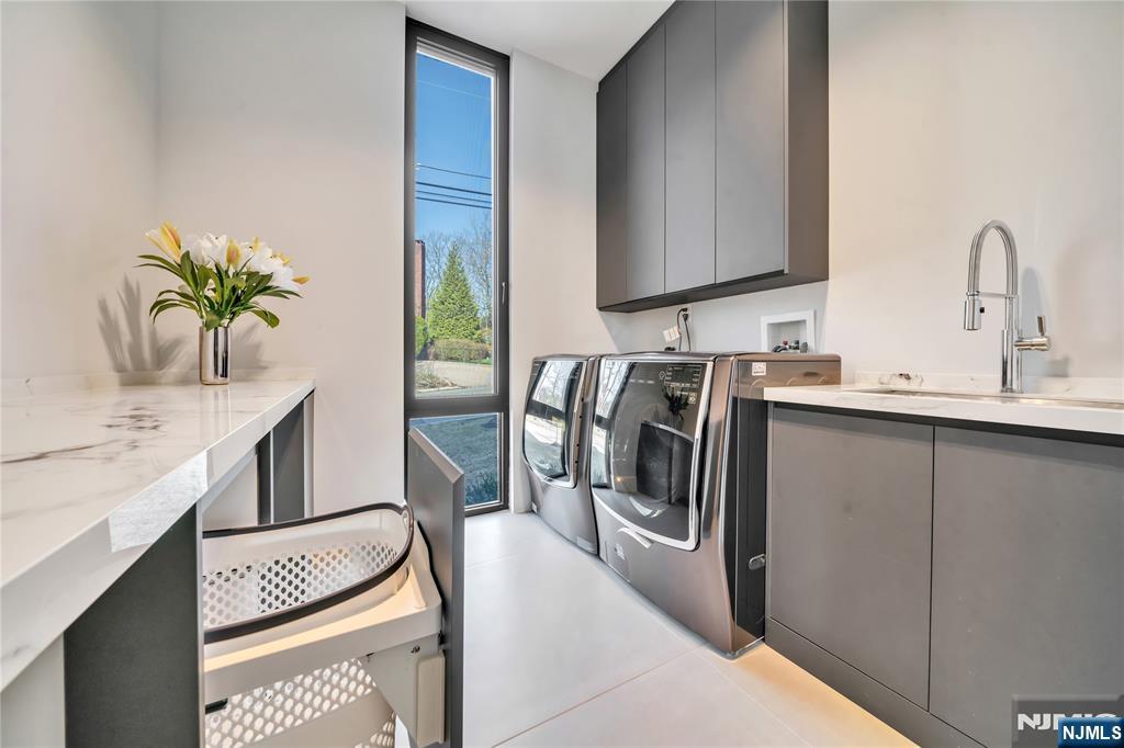 11 Roberts Road Englewood Cliffs, NJ 07632 - Photo 22 of 50 a kitchen with stainless steel appliances granite countertop a sink and a refrigerator