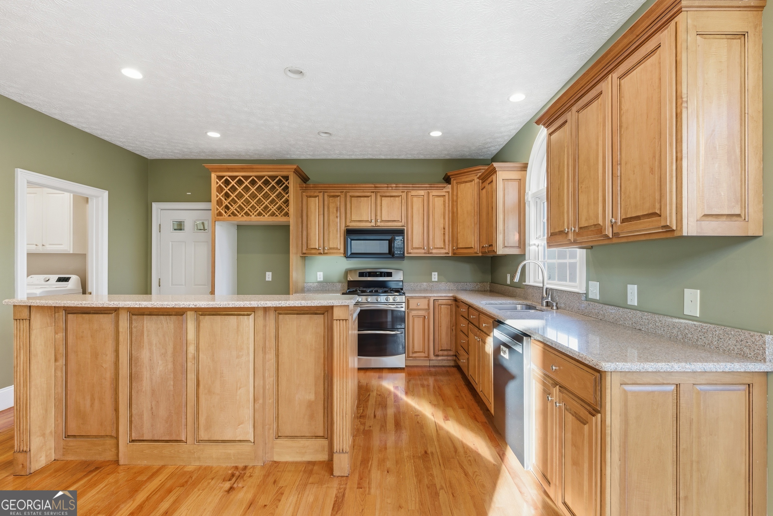 180 Springbrook Drive Cornelia, GA 30531 - Photo 12 of 50 a kitchen with stainless steel appliances granite countertop a stove a sink and a microwave