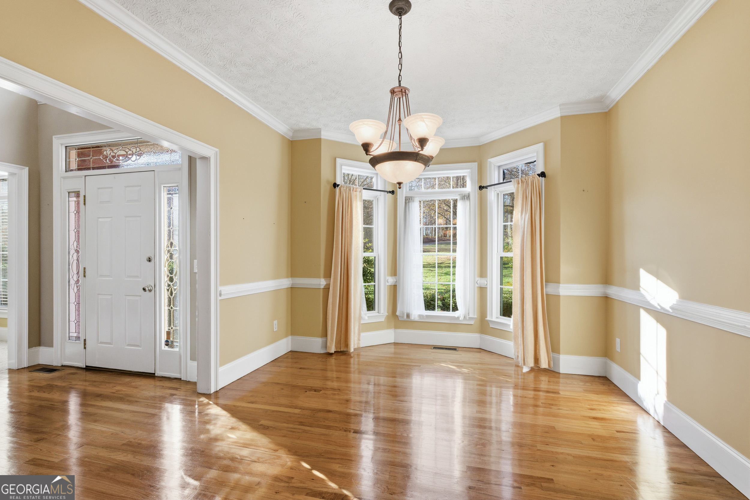 180 Springbrook Drive Cornelia, GA 30531 - Photo 16 of 50 a view of a hallway with wooden floor and a chandelier