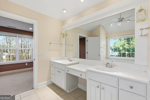 a bathroom with a sink double vanity and a large mirror