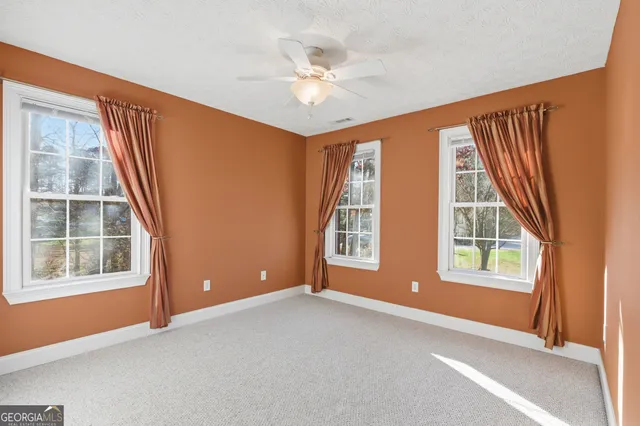 an empty room with windows and closet