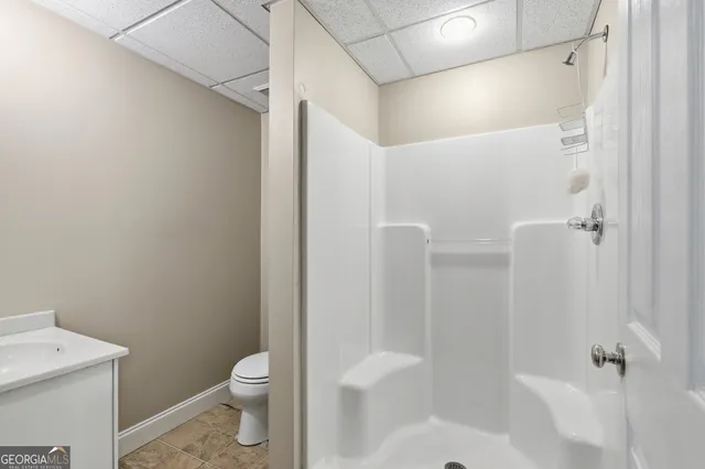 a bathroom with a toilet a sink and shower