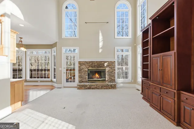 a view of an empty room with a fireplace and a window