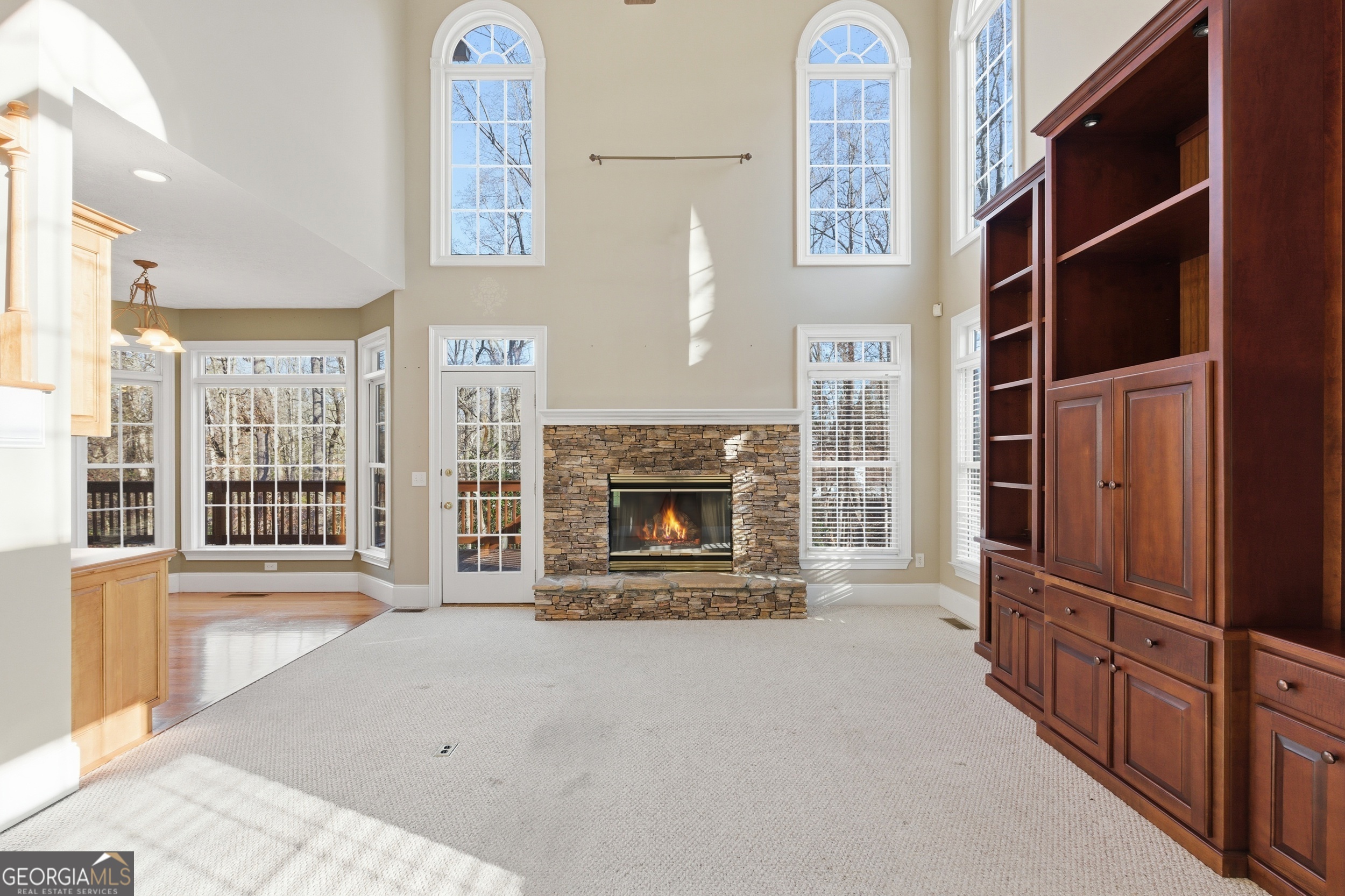 180 Springbrook Drive Cornelia, GA 30531 - Photo 9 of 50 a view of an empty room with a fireplace and a window