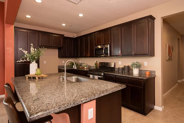 a kitchen with sink refrigerator and large window
