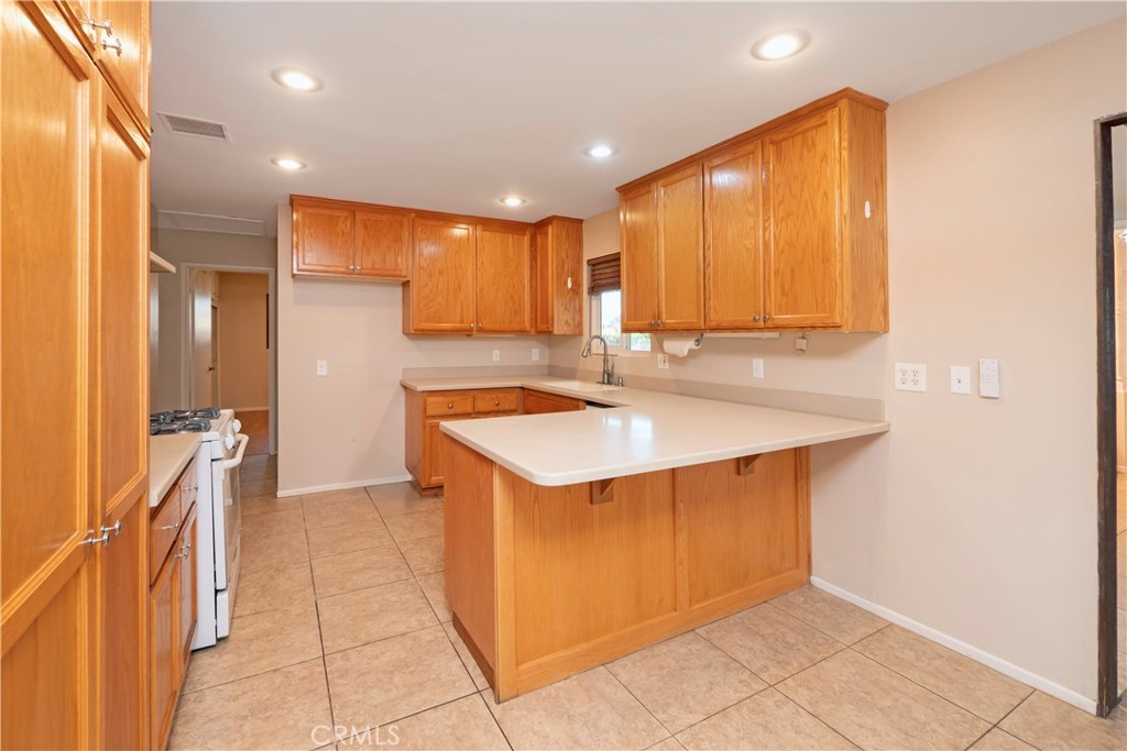 982 River Drive Norco, CA 92860 - Photo 12 of 41 a kitchen with a sink cabinets and wooden floor