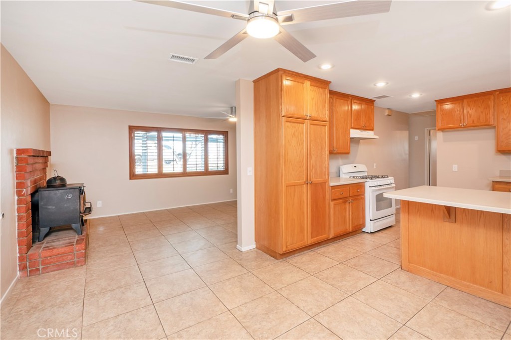 982 River Drive Norco, CA 92860 - Photo 13 of 41 a kitchen with a refrigerator a stove top oven a sink and cabinets