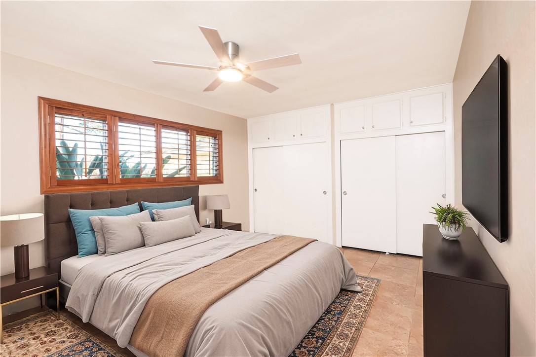 982 River Drive Norco, CA 92860 - Photo 21 of 41 a bedroom with a large bed and a flat tv screen on dresser