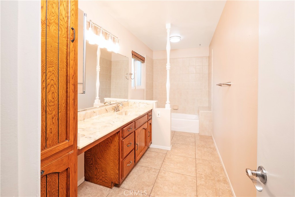 982 River Drive Norco, CA 92860 - Photo 28 of 41 a bathroom with a double vanity sink and a bathtub