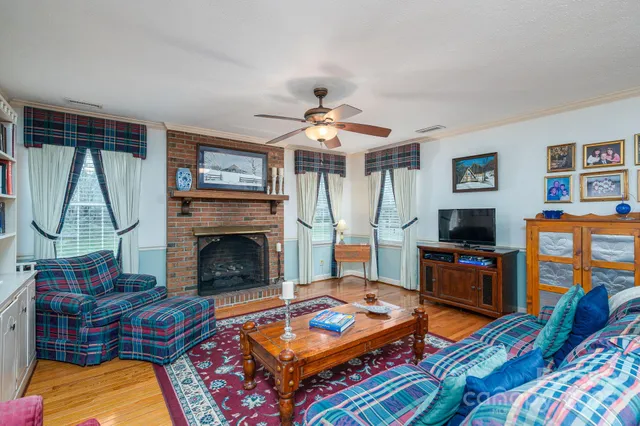 a living room with furniture fireplace and flat screen tv