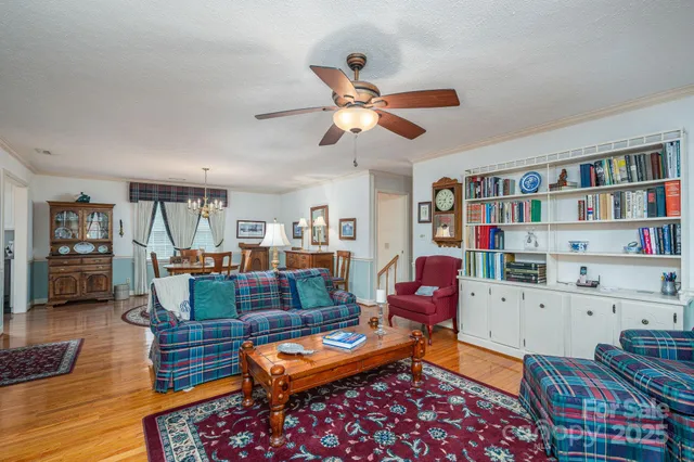 a living room with furniture a book shelf and a bookshelf