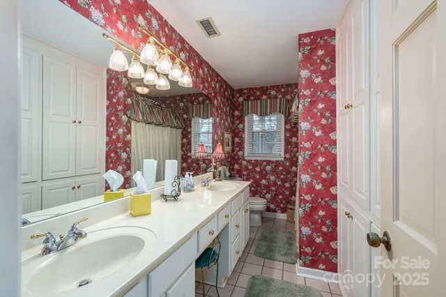 a bathroom with a sink vanity mirror and tub
