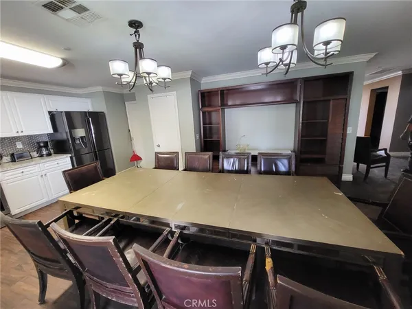 a view of a dining room with furniture and chandelier