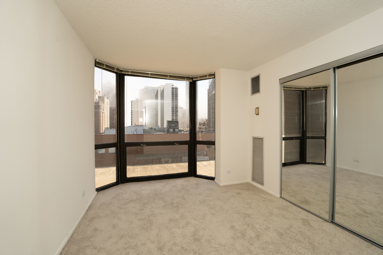 1111 North Dearborn Street, Unit 702 Chicago, IL 60610 - Photo 5 of 7 an empty room with windows and closet