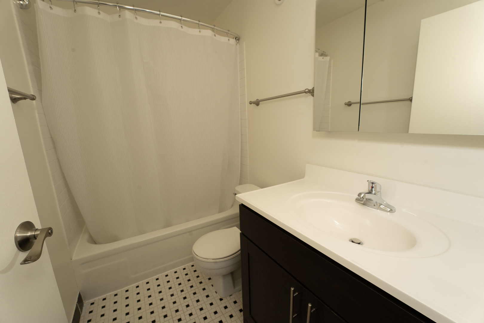 1111 North Dearborn Street, Unit 702 Chicago, IL 60610 - Photo 7 of 7 a bathroom with a sink a toilet a shower and a mirror