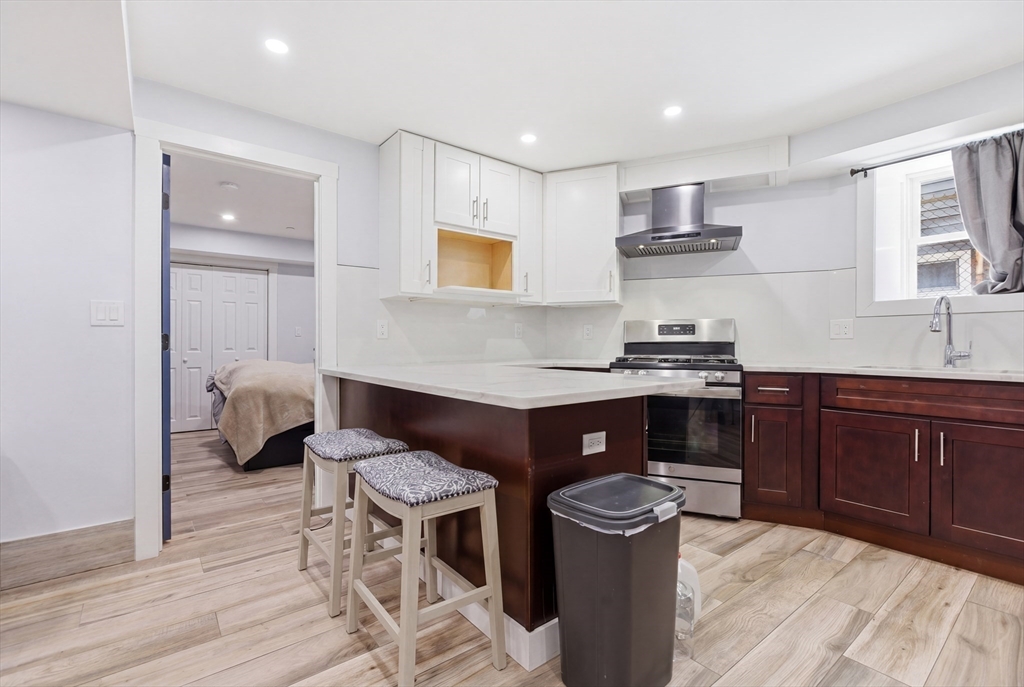 61 Shepton Street Boston, MA 02124 - Photo 15 of 41 a kitchen with stainless steel appliances granite countertop a stove and a sink