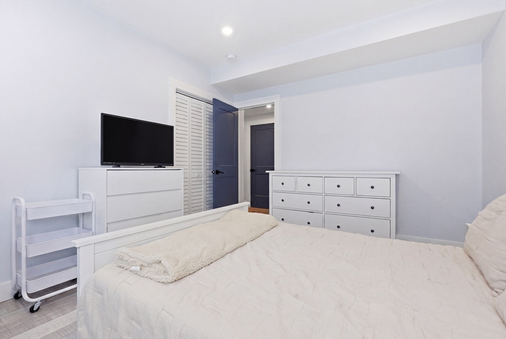 61 Shepton Street Boston, MA 02124 - Photo 16 of 41 a bedroom with a bed and a flat screen tv