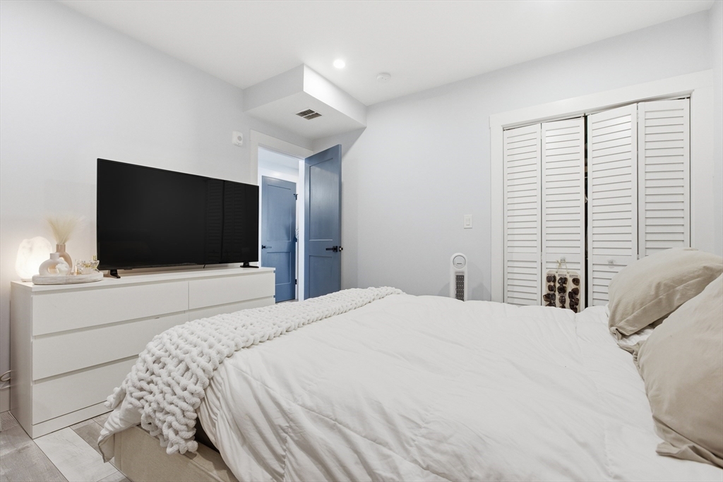 61 Shepton Street Boston, MA 02124 - Photo 18 of 41 a bedroom with a bed and a flat screen tv