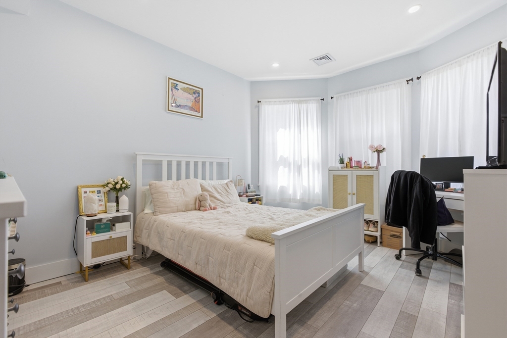 61 Shepton Street Boston, MA 02124 - Photo 23 of 41 a bedroom with a bed and a chair