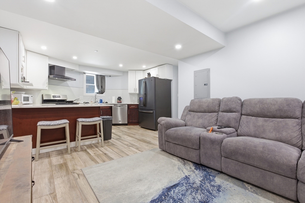61 Shepton Street Boston, MA 02124 - Photo 25 of 41 a living room with a couch and a kitchen view
