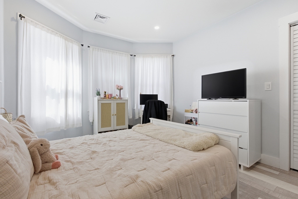 61 Shepton Street Boston, MA 02124 - Photo 29 of 41 a bedroom with a bed tv and a window