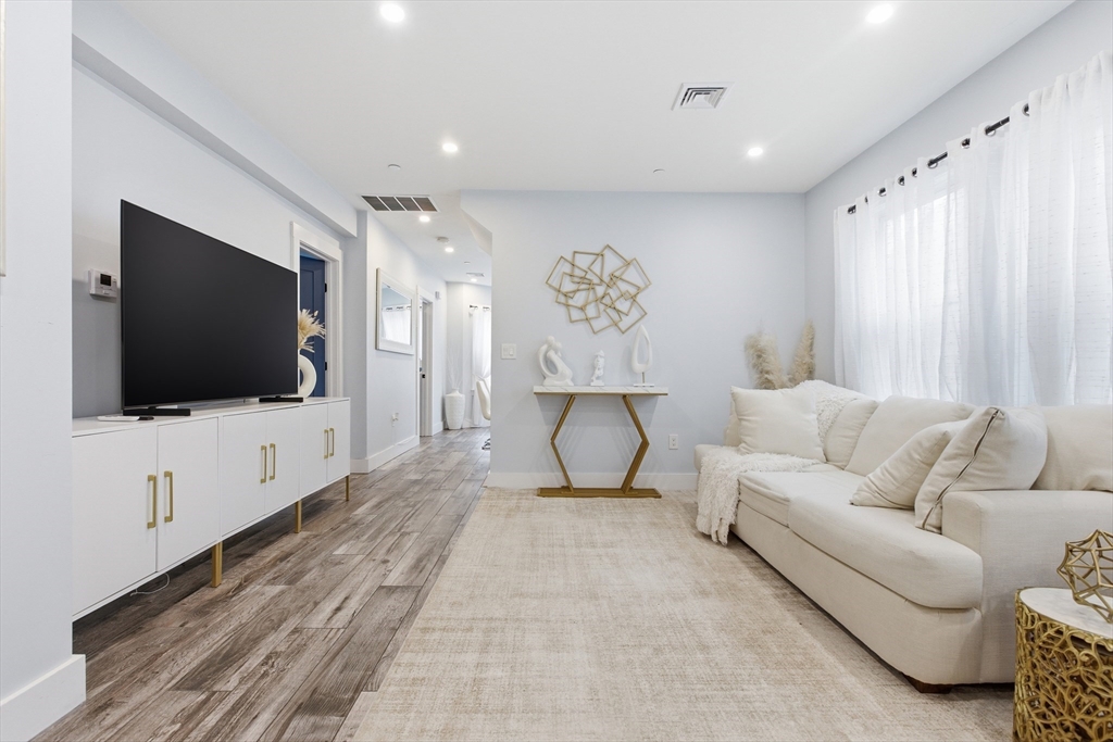 61 Shepton Street Boston, MA 02124 - Photo 3 of 41 a living room with furniture and a flat screen tv