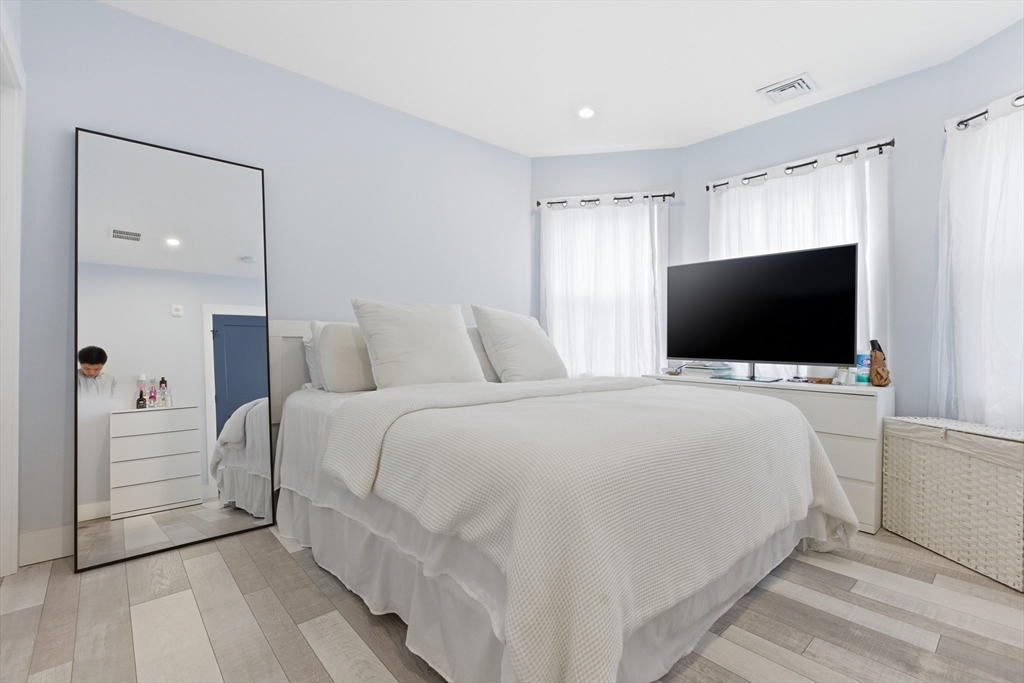 61 Shepton Street Boston, MA 02124 - Photo 31 of 41 a bedroom with a bed and a flat screen tv