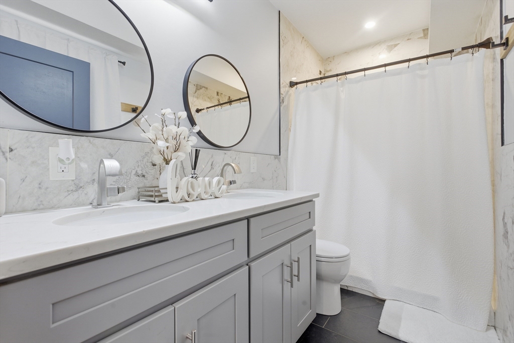 61 Shepton Street Boston, MA 02124 - Photo 33 of 41 a bathroom with a double vanity sink mirror and toilet
