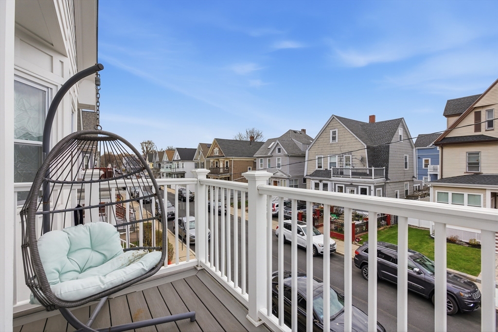 61 Shepton Street Boston, MA 02124 - Photo 37 of 41 a view of a brick house with floor to ceiling windows and wooden deck