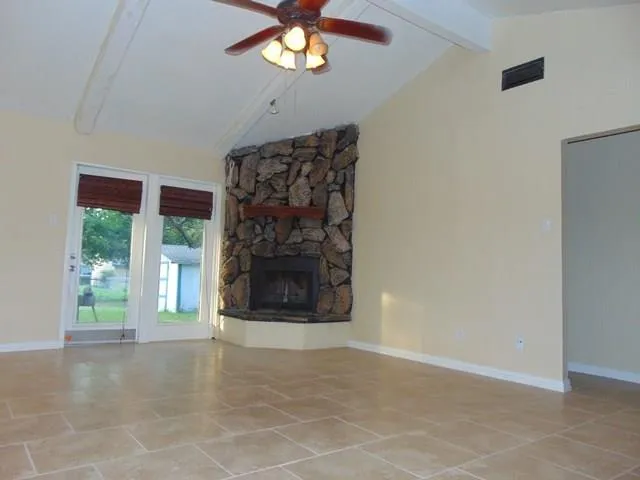 a view of a livingroom with a fireplace and window
