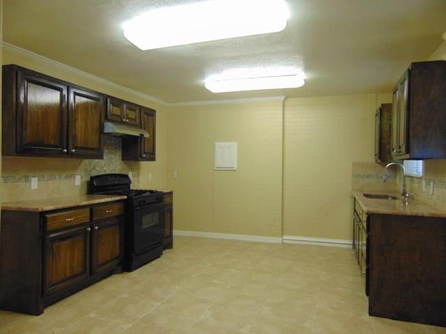1201 Rambler Road Arlington, TX 76014 - Photo 4 of 15 a kitchen with stainless steel appliances granite countertop a sink stove and refrigerator