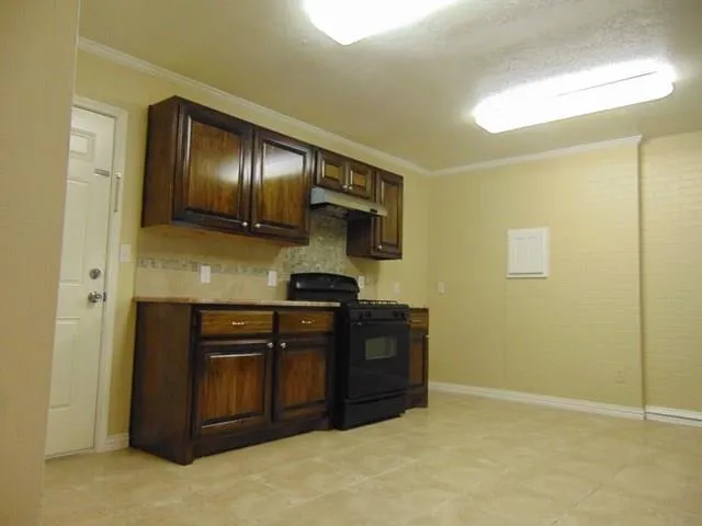 a kitchen with stainless steel appliances granite countertop a stove and a refrigerator