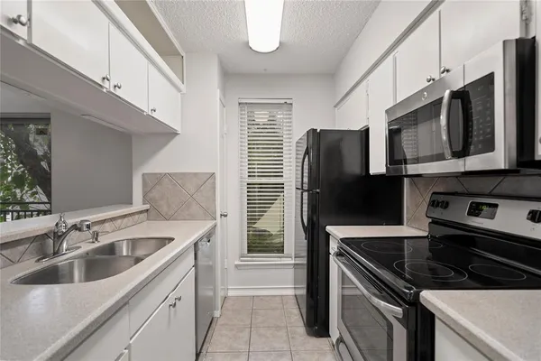 a kitchen that has a sink and a stove