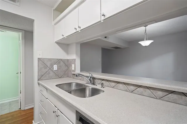 a kitchen with a sink and cabinets