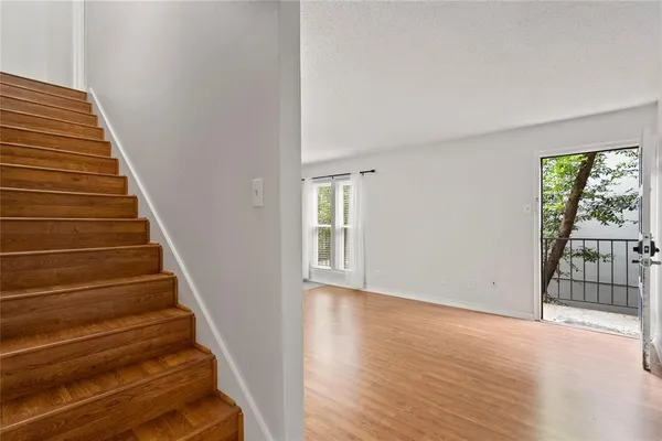 a view of entryway with wooden floor and stairs