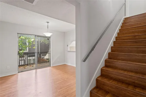 a view of entryway and hall with wooden floor