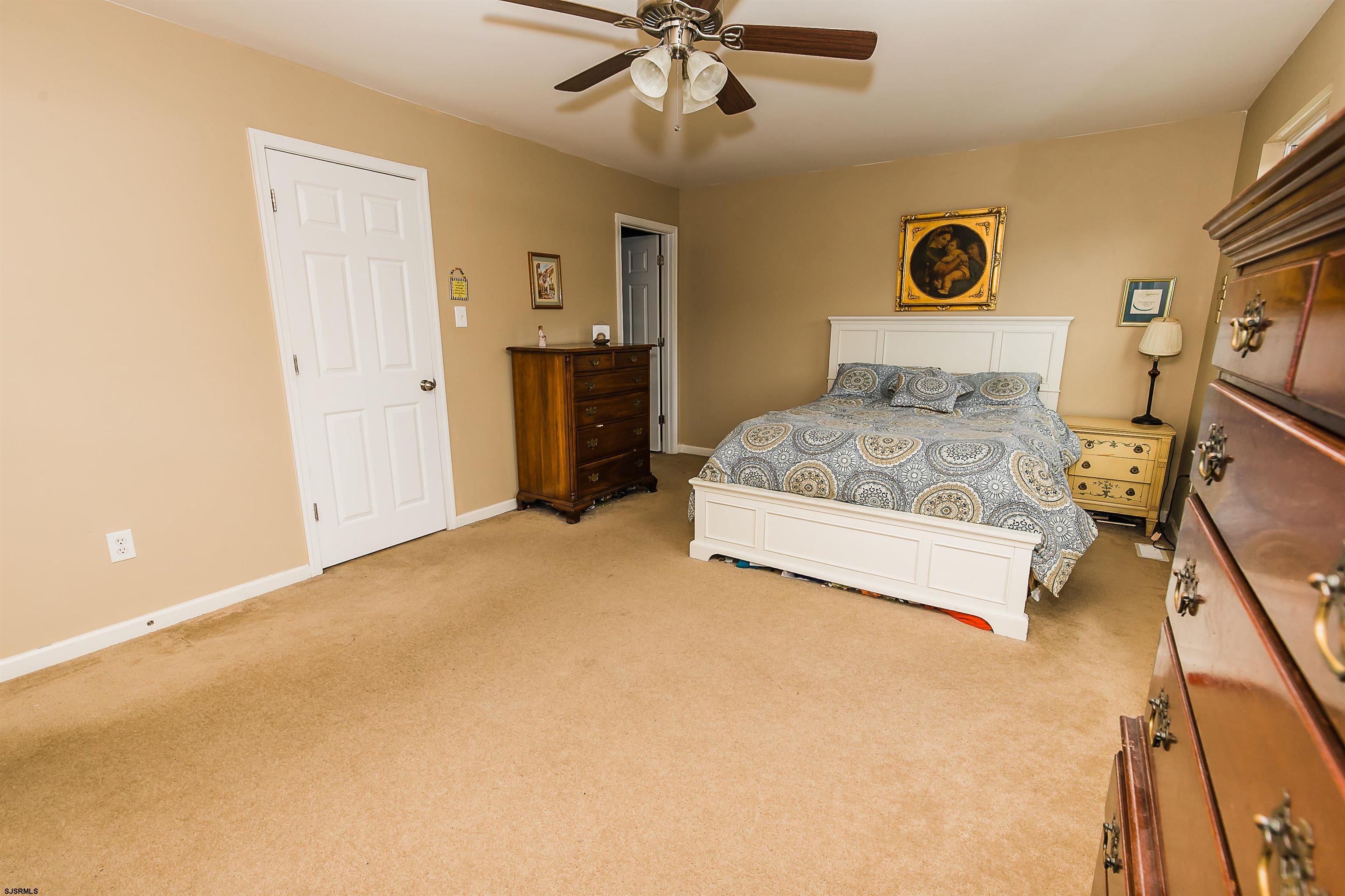 16 Cottage Road Egg Harbor Township, NJ 08234 - Photo 14 of 24 a bedroom with a bed and cabinets