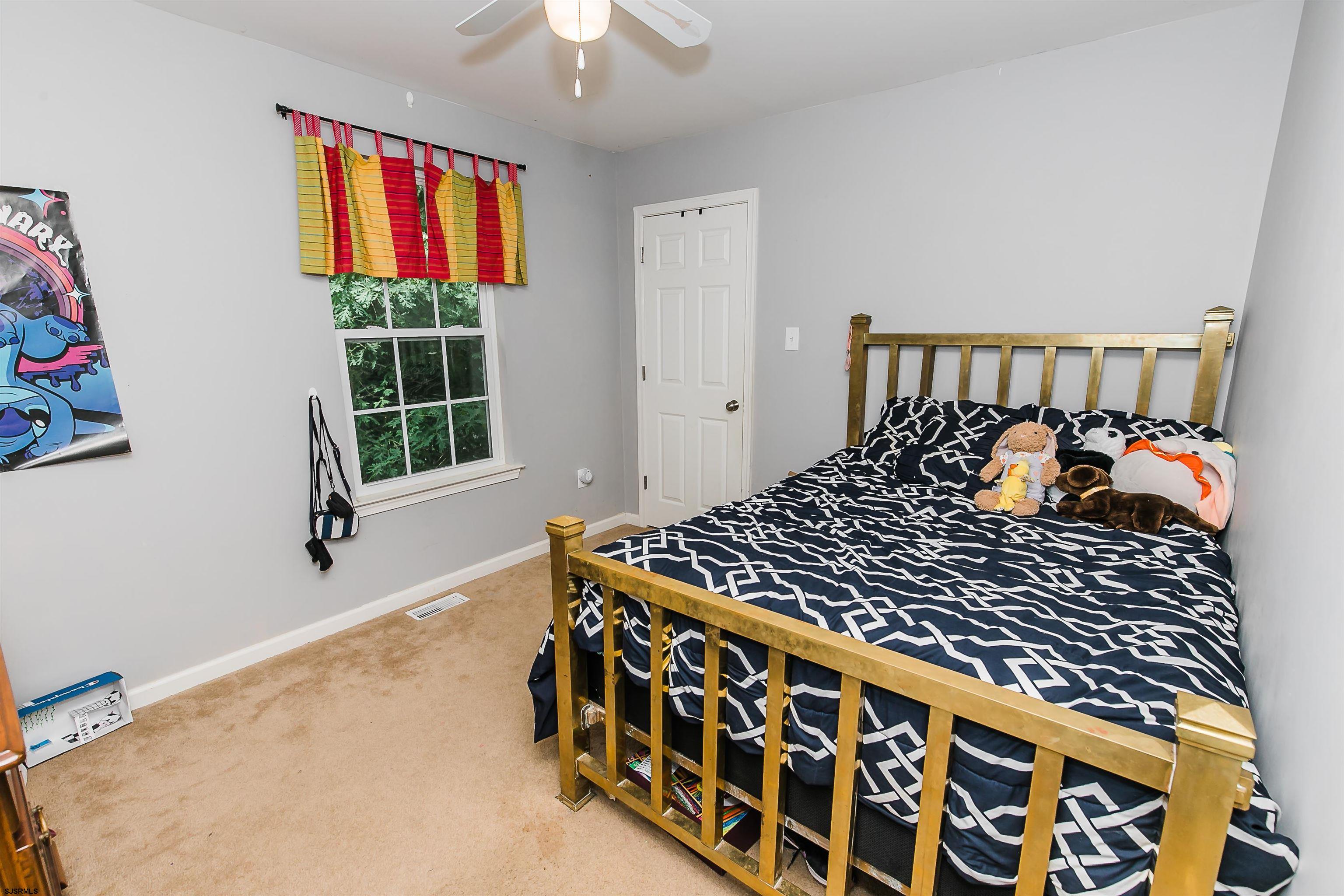 16 Cottage Road Egg Harbor Township, NJ 08234 - Photo 17 of 24 a bedroom with a bed and window