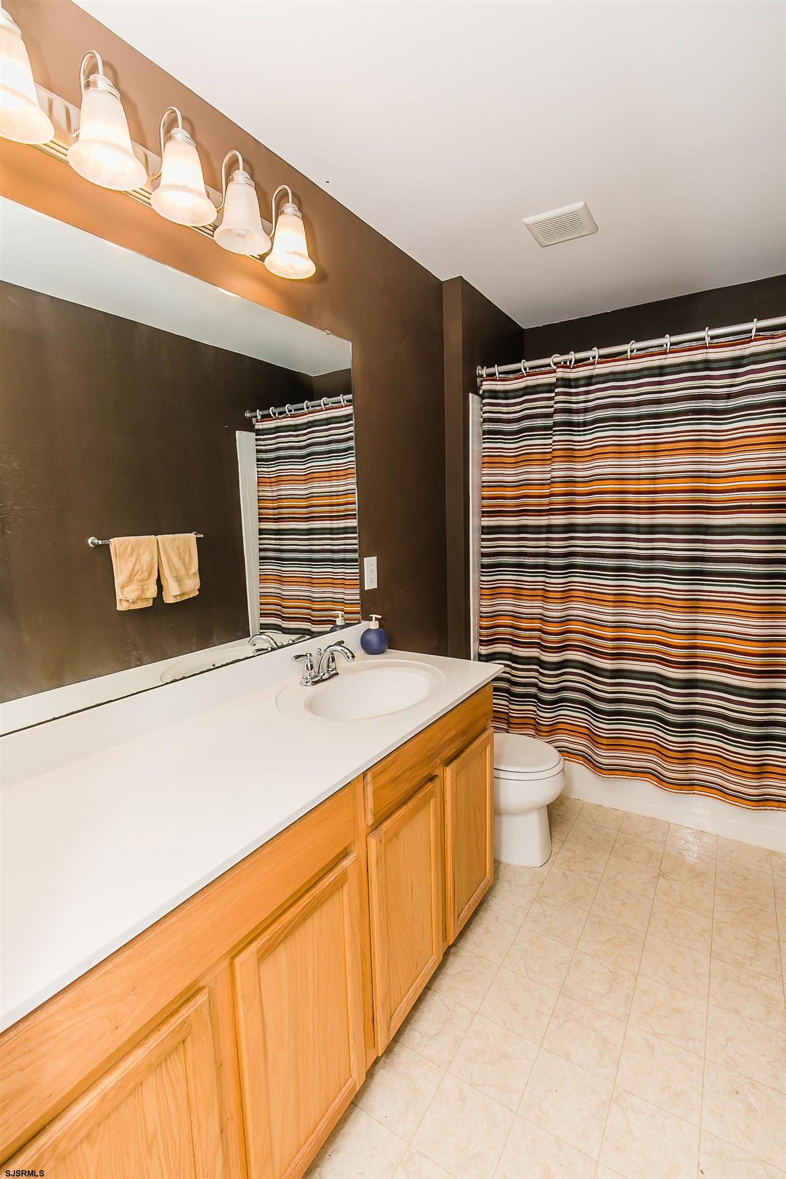 16 Cottage Road Egg Harbor Township, NJ 08234 - Photo 22 of 24 a bathroom with a sink a toilet and shower