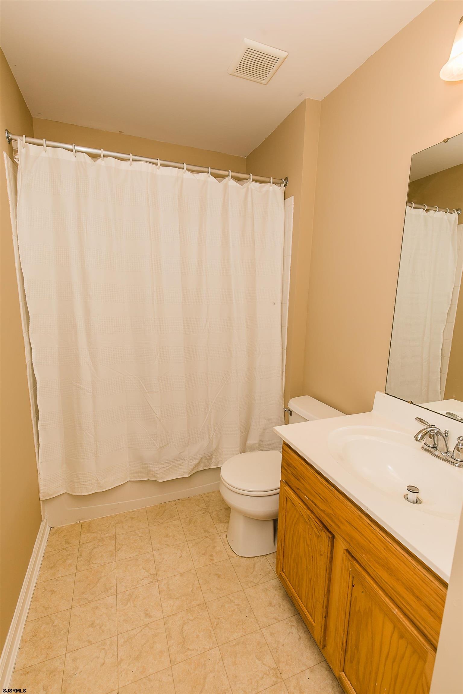 16 Cottage Road Egg Harbor Township, NJ 08234 - Photo 23 of 24 a bathroom with a sink a toilet and shower curtain