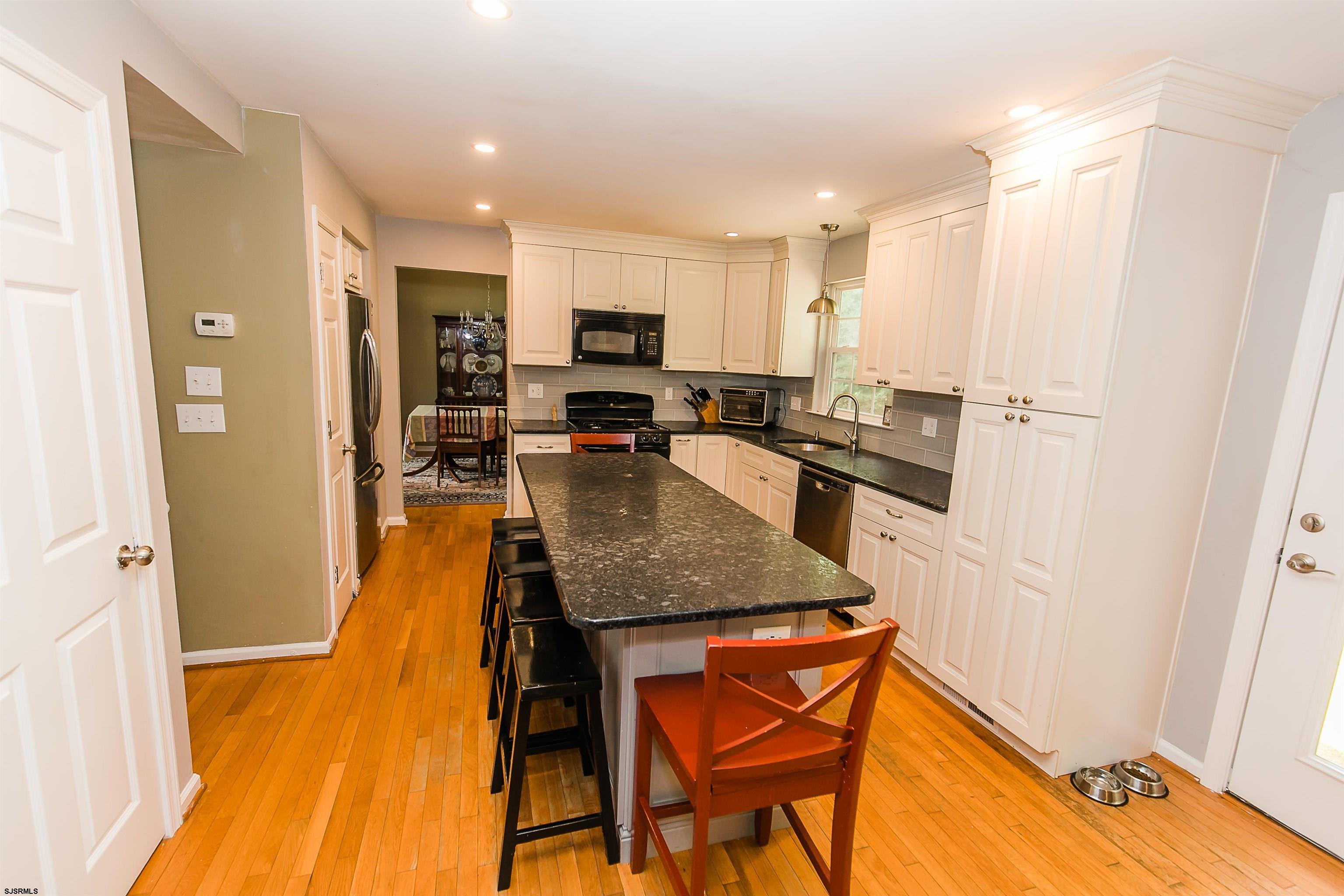 16 Cottage Road Egg Harbor Township, NJ 08234 - Photo 5 of 24 a kitchen with stainless steel appliances granite countertop sink refrigerator and microwave