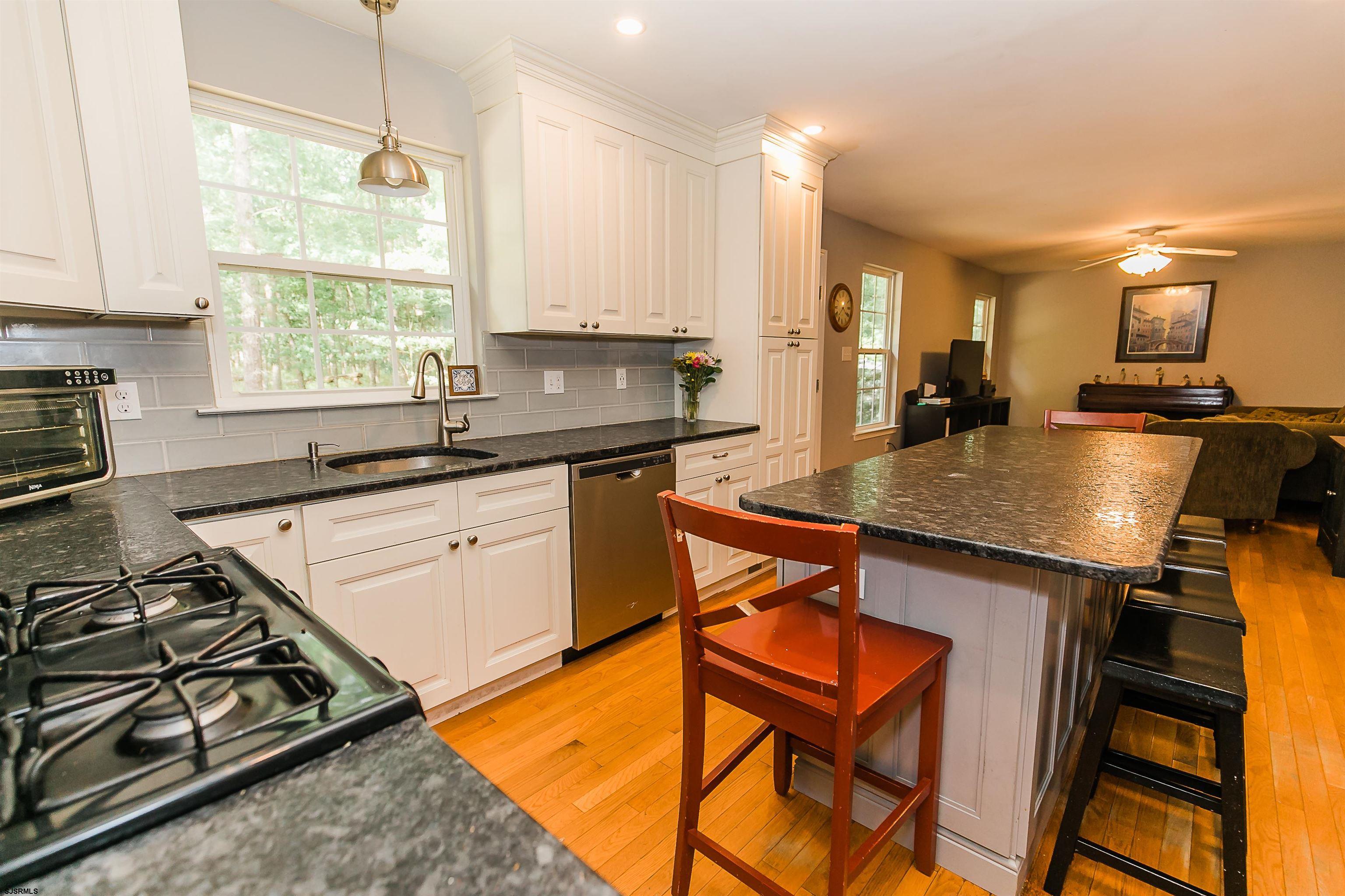 16 Cottage Road Egg Harbor Township, NJ 08234 - Photo 7 of 24 a kitchen with stainless steel appliances granite countertop a sink stove and refrigerator
