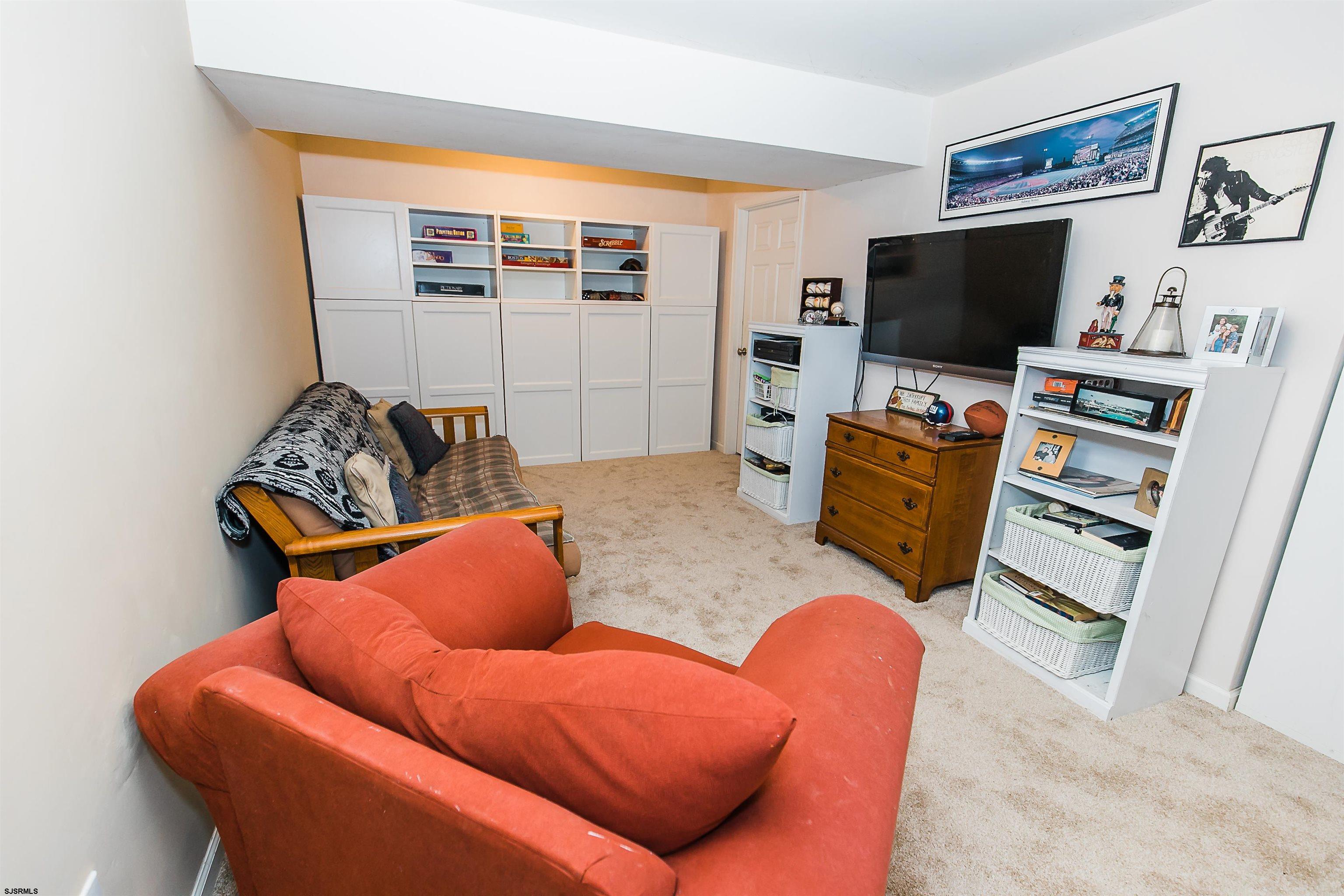 16 Cottage Road Egg Harbor Township, NJ 08234 - Photo 8 of 24 a living room with furniture and a flat screen tv