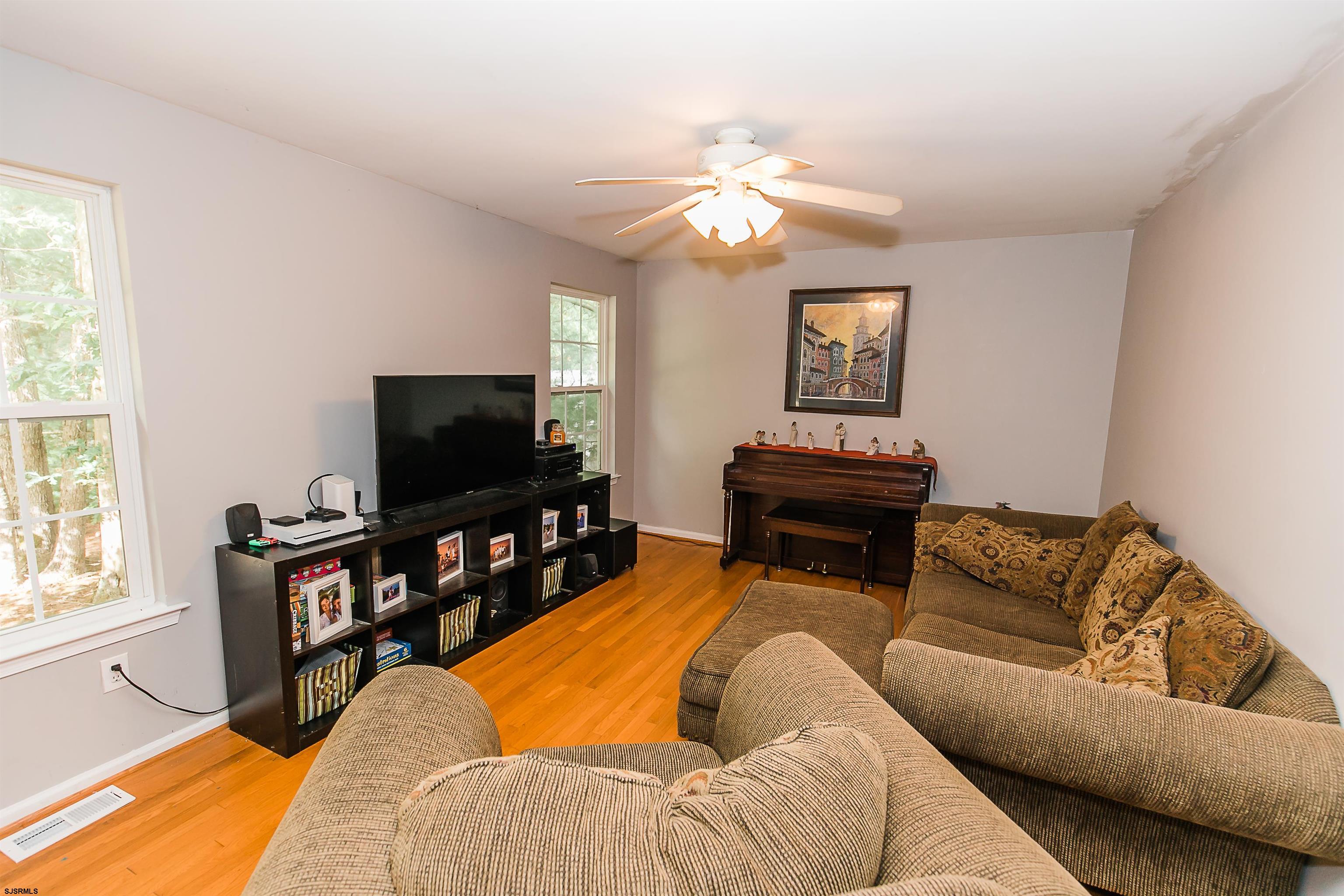 16 Cottage Road Egg Harbor Township, NJ 08234 - Photo 10 of 24 a living room with furniture and a flat screen tv