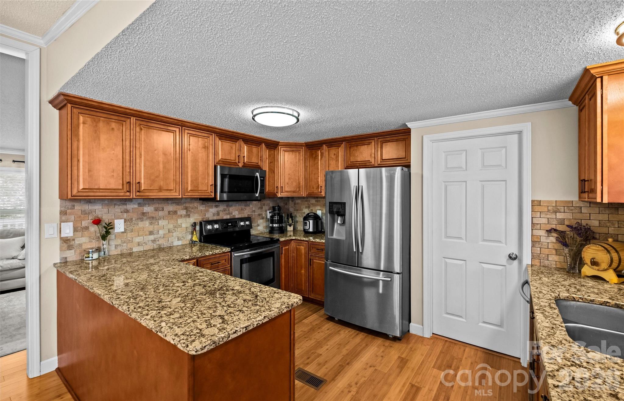 122 Julius Mac Road Stanley, NC 28164 - Photo 10 of 17 a kitchen with stainless steel appliances granite countertop a refrigerator stove top oven and sink