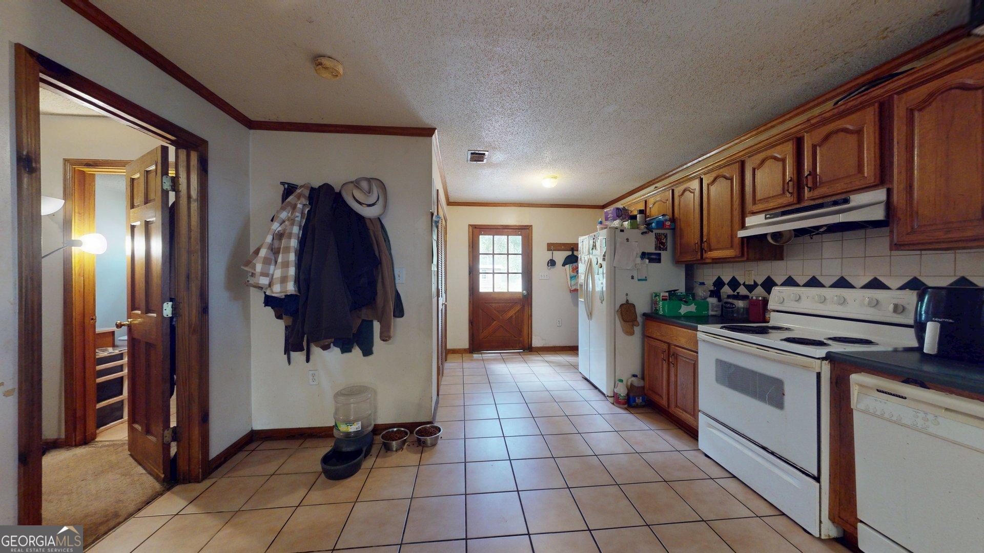 450 Bellevue Plantation Road Millen, GA 30442 - Photo 11 of 25 a kitchen with stainless steel appliances granite countertop a refrigerator and a stove top oven