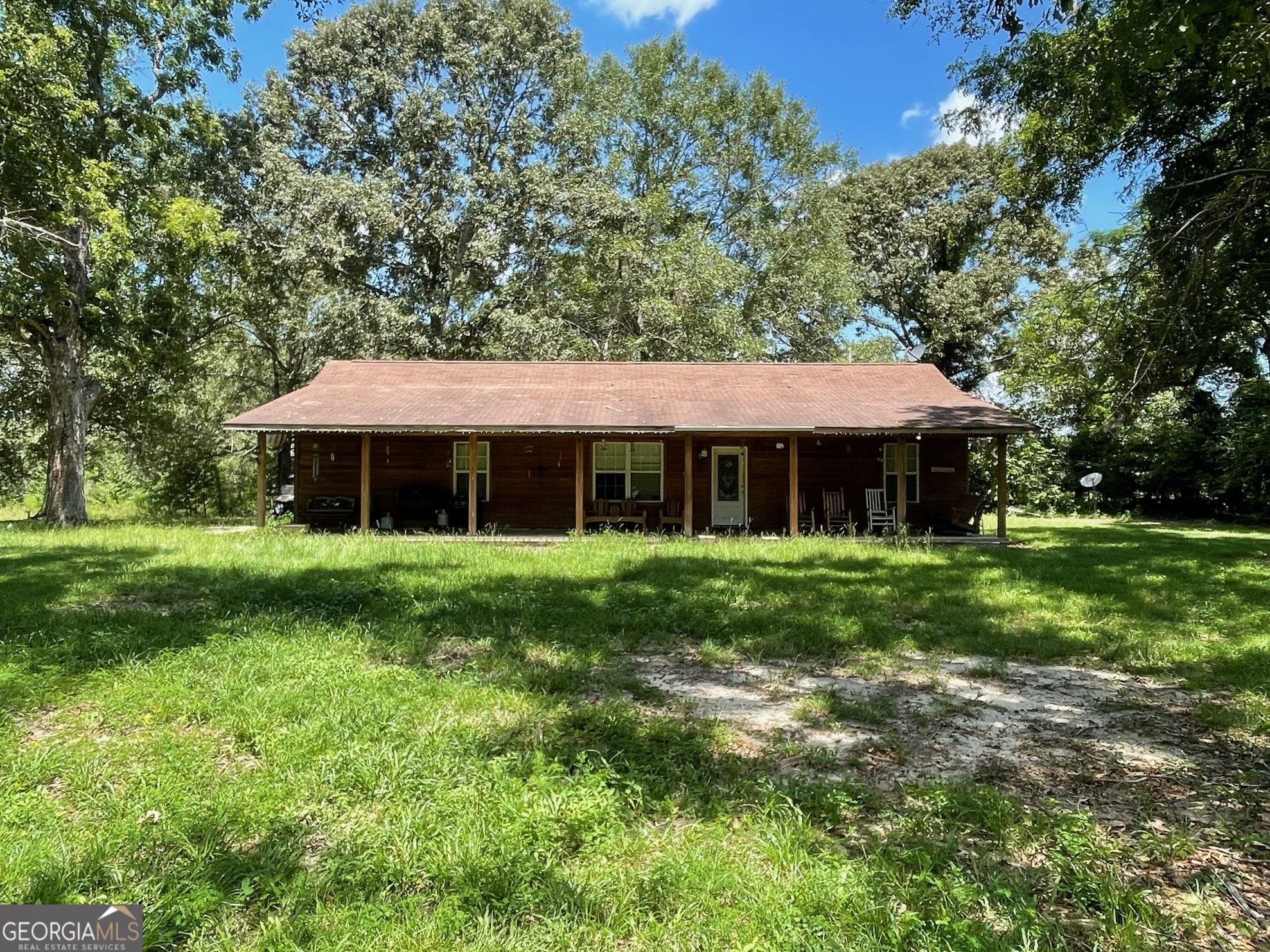 450 Bellevue Plantation Road Millen, GA 30442 - Photo 2 of 25 a front view of a house with a yard table and chairs